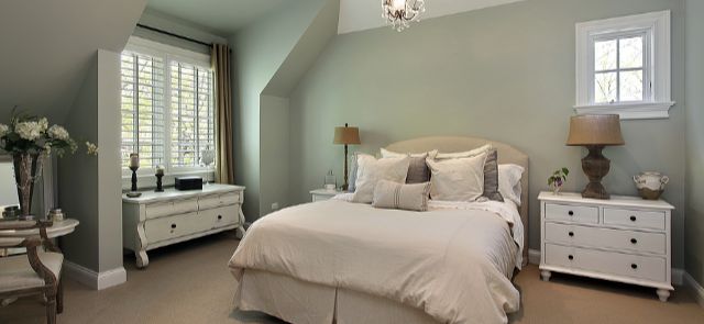 Bedroom With White Shutters On The Windows.
