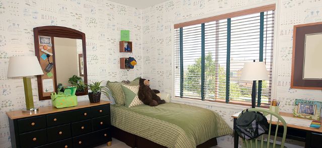 A Child'S Room With Ample Light Being Let In By Interior Shutters.