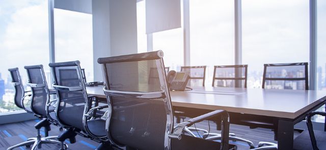 An Empty Conference Room With Window Treatments To Block The Sun